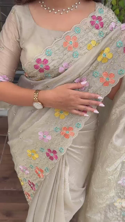 A perfect festive beauty, Grace meets glamour in this ethereal dusty beige colored saree adorned with exquisite beads embroidery with thread work. Perfect for any celebration.